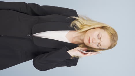 Vertical-video-of-Business-woman-getting-interrupted-and-angry-while-talking-on-the-phone.
